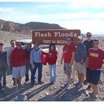 Students at a flash flood warning sign